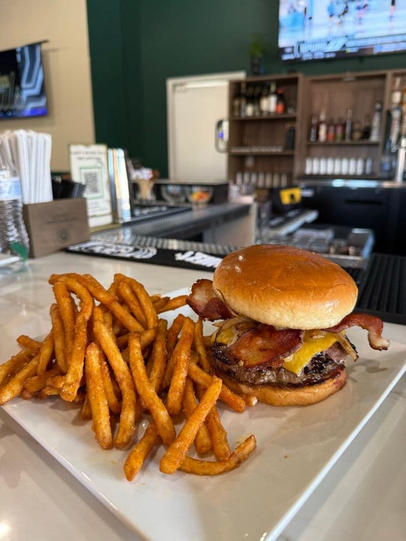 A bacon cheeseburger with seasoned fries